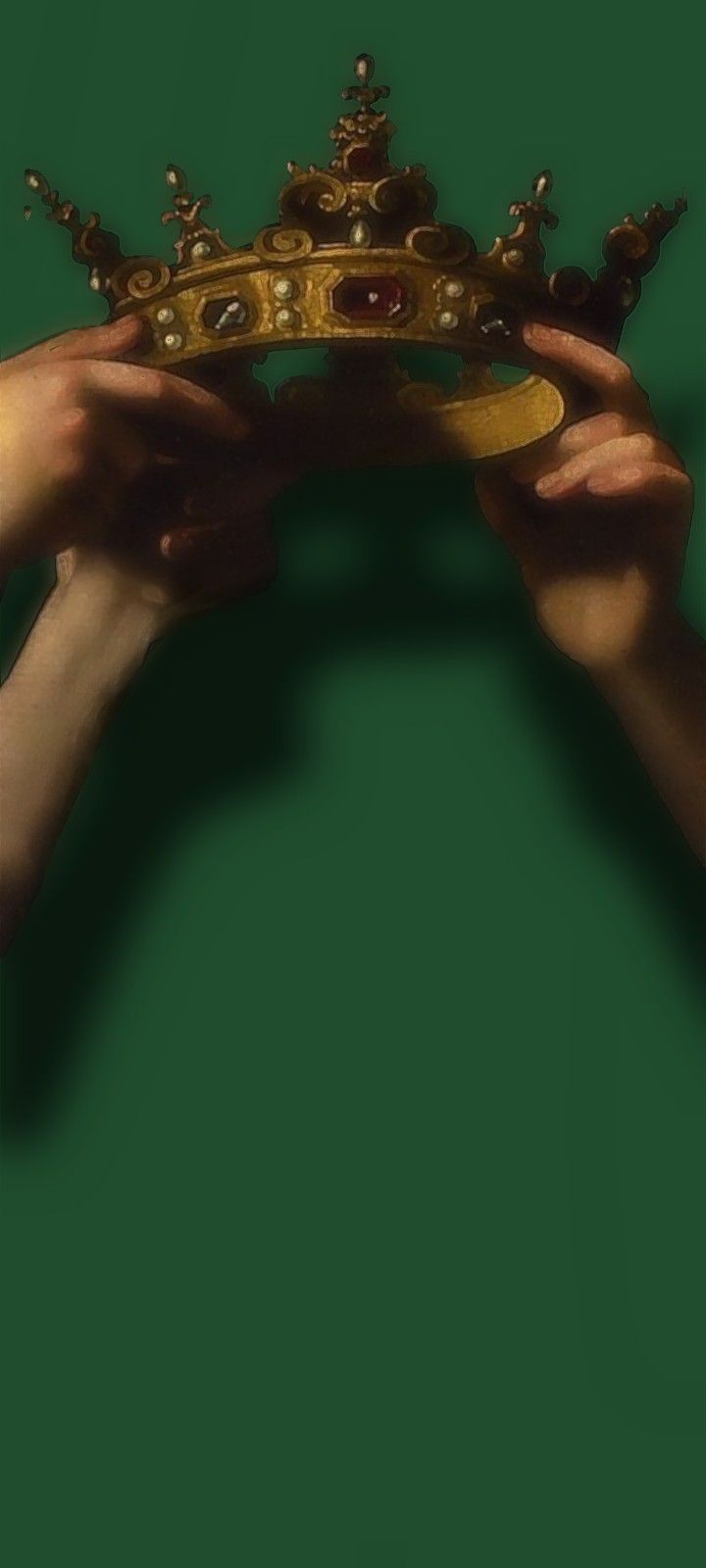 two hands holding a golden crown against a green background