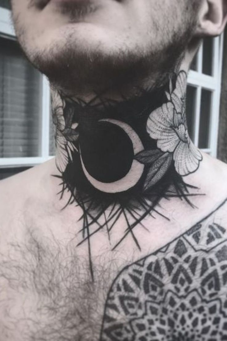 a man with tattoos on his chest has a crescent and flower design on the neck