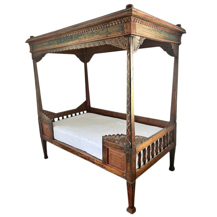 an old wooden bed with white sheets and pillows on it's sides, against a white background