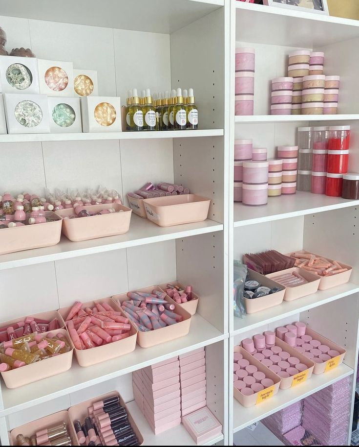 shelves filled with lots of different types of cakes and confection containers on them