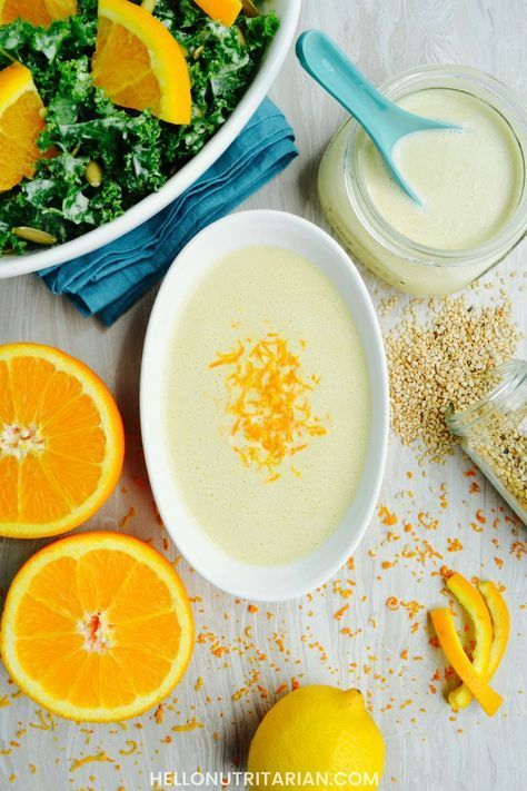 a bowl of soup with oranges and other ingredients around it