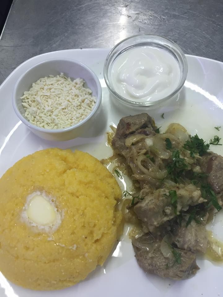 a white plate topped with food and two small bowls filled with different types of food