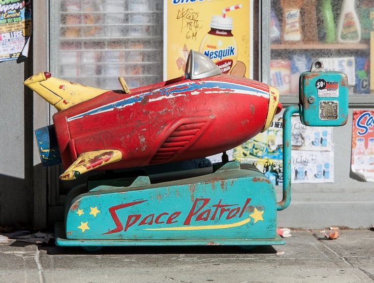 an old toy boat is on display in front of a store