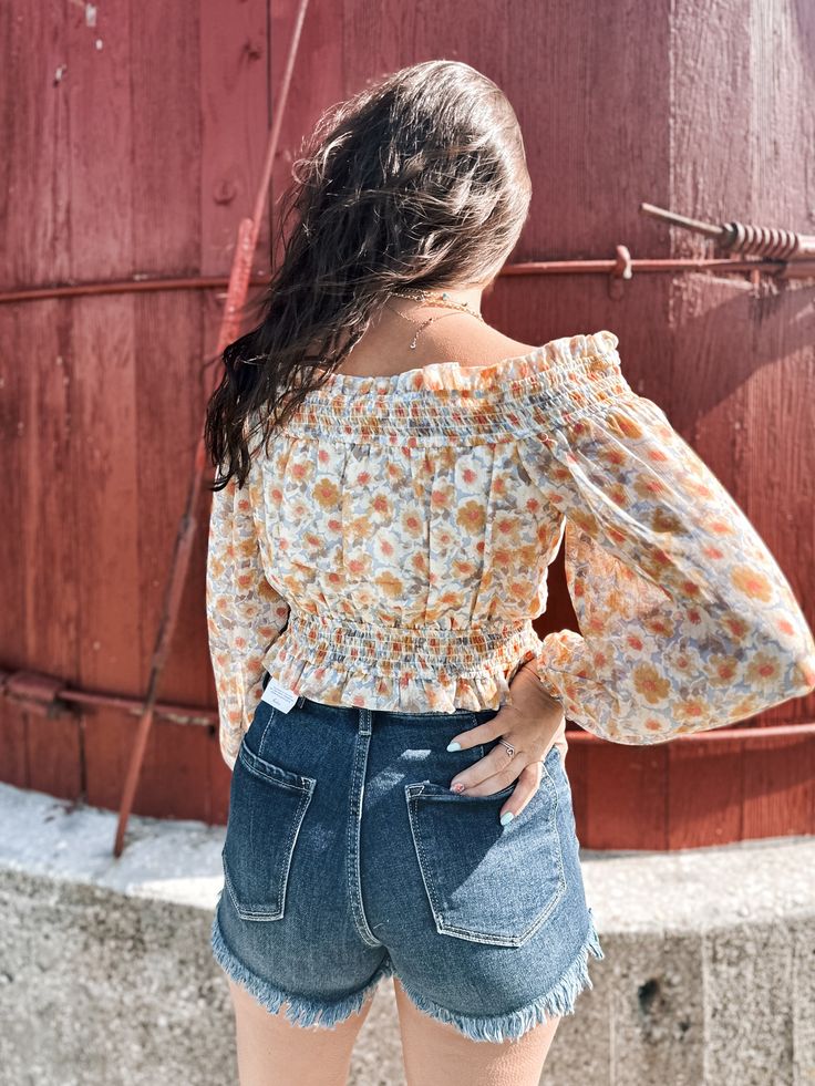 floral print, woven blouse with the following features: Smocked, off-shoulder neckline with ruffle. Long bubble sleeves with elastic cuffs. Smocked elastic waist. Low back. Ruffle hem. Cropped length. Sleeveless lining. Relaxed fit. model 5.4” shown in true size small Spring Long Sleeve Off-shoulder Top With Smocked Bodice, Casual Off-shoulder Smocked Top For Spring, Spring Off-shoulder Smocked Top For Day Out, Summer Off-shoulder Blouse With Elastic Sleeves, Fall Season Off-shoulder Smocked Top, Spring Flowy Peasant Top With Smocked Back, Off-shoulder Blouse With Smocked Back, Summer Floral Print Long Sleeve Smocked Top, Casual Off-shoulder Top With Smocked Back