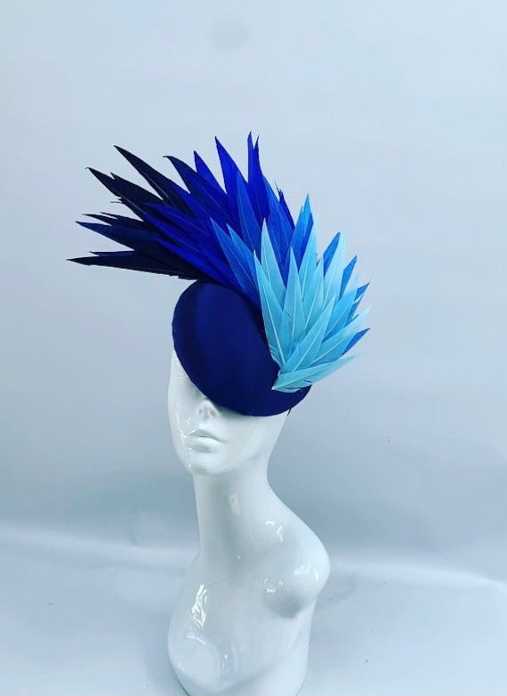 This stunning handmade feather winged design is created using a variation of blue  feathers applied to a silk base this piece can be created in a variety of colours and is a real statement piece perfect for a mother of the bride or wedding guest sure to cause a stir at any event. Unique Hat Design, Headgear Design, Honk Jr, The Wizard Of Oz Costumes, Hat Feathers, Art Deco Hats, Stylish Womens Hats, Fascinator Hats Diy, Church Lady Hats