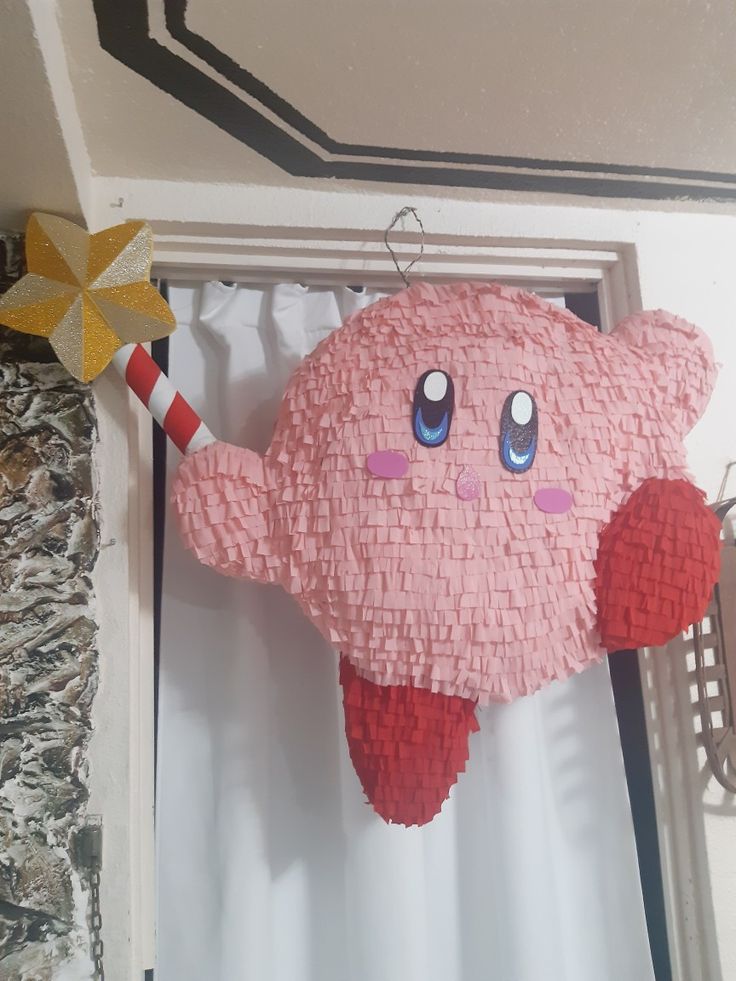 a pink stuffed animal hanging from the ceiling