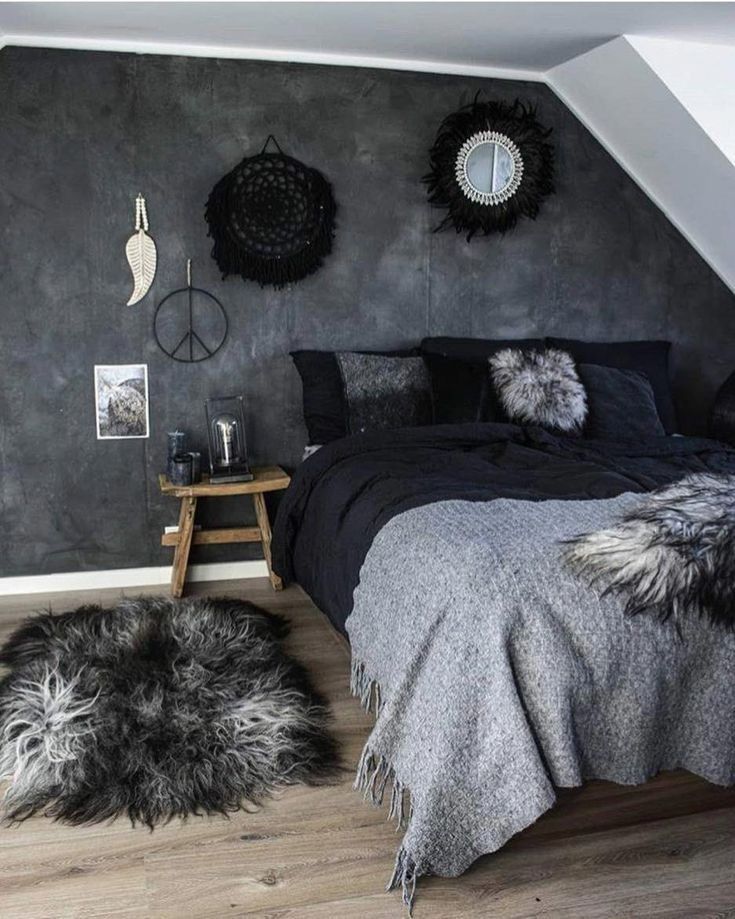 a bedroom with black and white decor on the walls, rugs and bedding