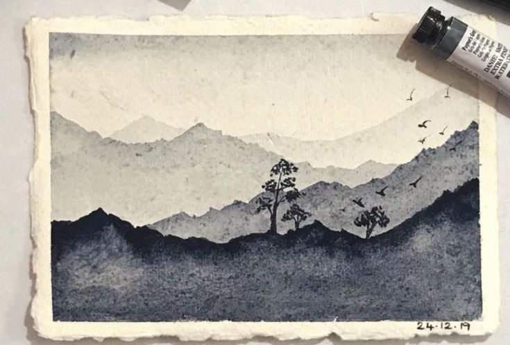 an ink drawing of mountains and trees with birds flying over them on a piece of paper