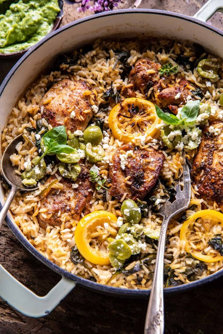 a pan filled with rice, meat and vegetables