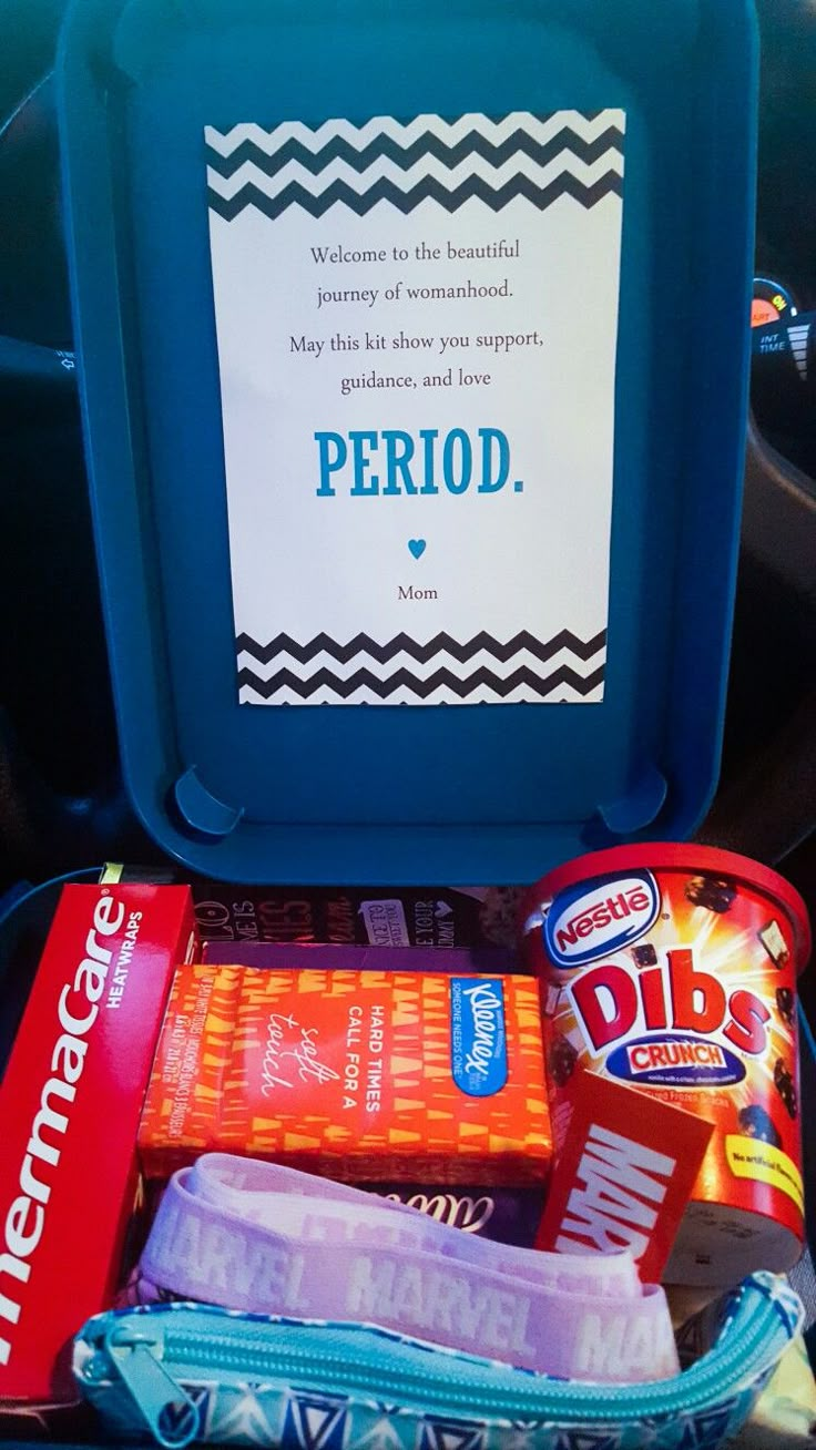 an open lunchbox with snacks and candy in it that says period on the side