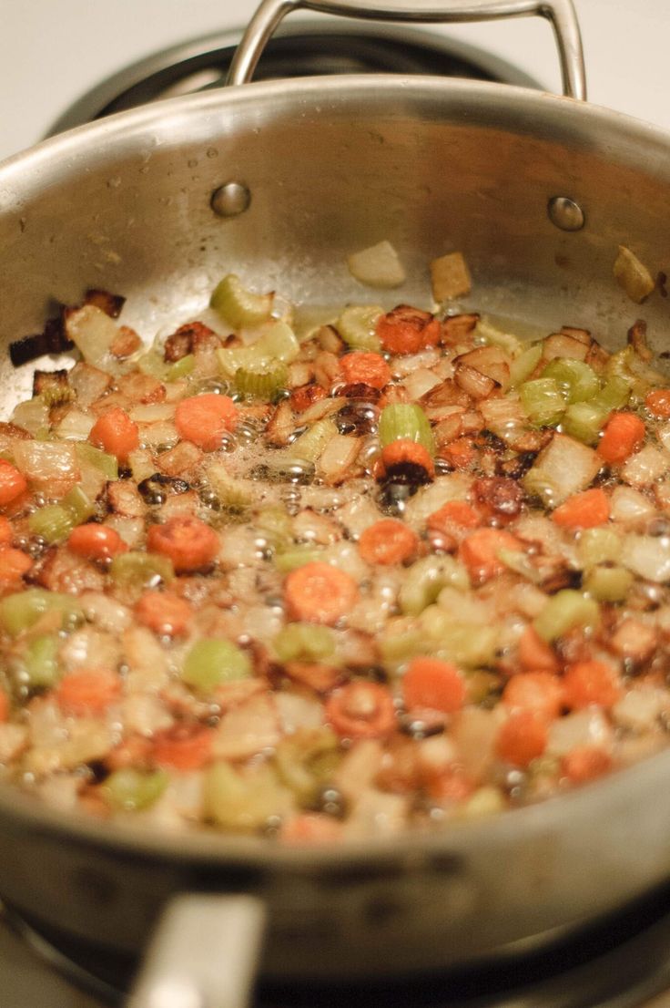 a pan filled with food sitting on top of a stove