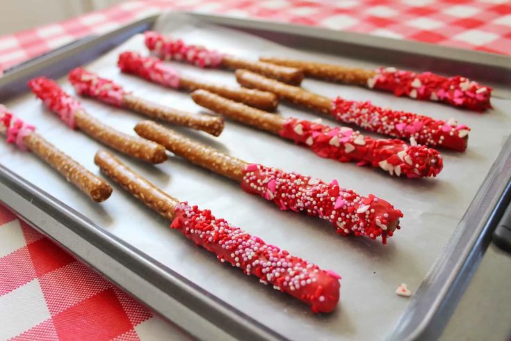 there are many pretzels on the tray ready to be cooked in the oven