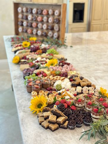 a long table filled with lots of different types of desserts on top of it