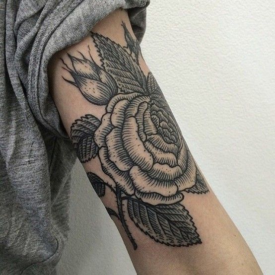 two pictures of a woman's arm with flowers and leaves tattooed on the arm