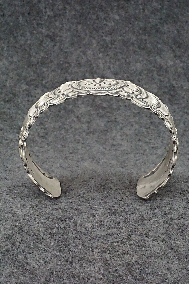 This stunning and intricate sterling silver bracelet was made by Navajo silversmith Eugene Charley. The inside is signed and stamped sterling.Size: 6" (will fit up to a 7 3/8" wrist)Gap: 1 3/8"Width: 1 1/2"Free shipping on all orders! We ship with USPS and always include tracking. All orders ship within a day of payment.Returns are accepted up to 30 days after you receive your order. Just send us a message. Our shop offers cash back or store credit. The item must be returned in new condition. Sterling Silver Bracelet, Sterling Silver Bracelets, Silver Bracelet, Gap, Stamp, Size 6, Bracelet, Sterling Silver, Free Shipping