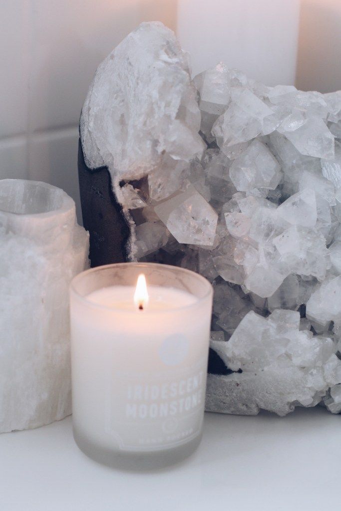 a candle and some rocks on a table