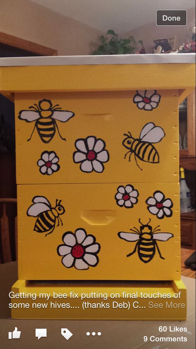 a yellow dresser with bees painted on the drawers and flowers drawn on the bottom part