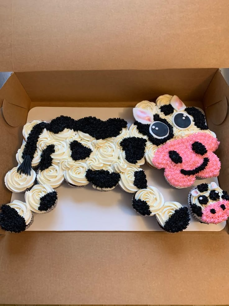 a cake shaped like a cow in a box