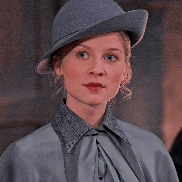 a woman wearing a gray hat and dress shirt