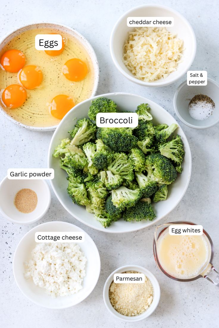 broccoli, eggs, rice and other ingredients in bowls on a white surface