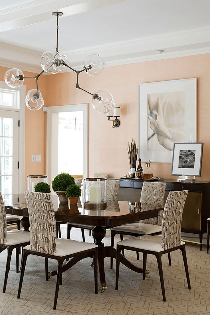 a dining room table and chairs with chandelier in the middle of the room