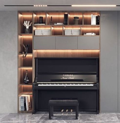 a piano is sitting in the middle of a room with built - in shelving