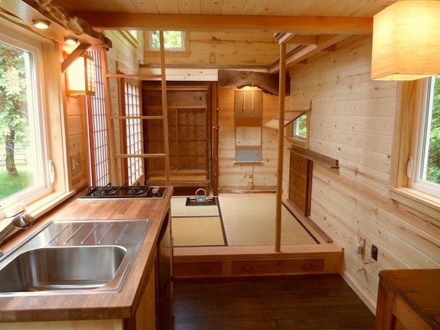 a kitchen area with sink, stove and window in the house that is built into the wall