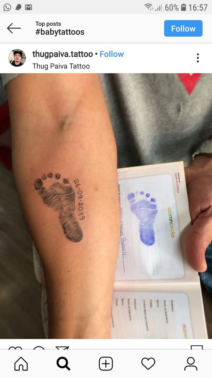 a person with a tattoo on their arm that has a baby foot print on it