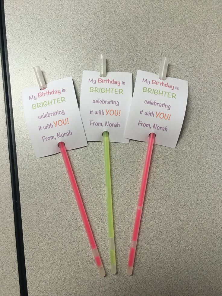 four birthday wish tags on top of a refrigerator freezer with pink and green straws