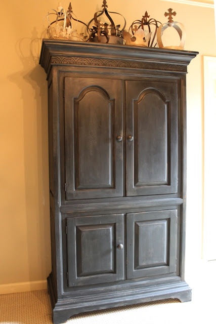 an old black armoire in a room