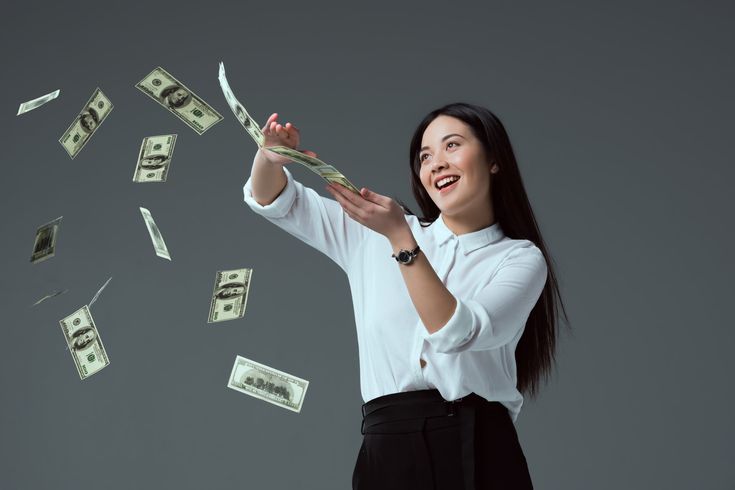 a woman is throwing money into the air