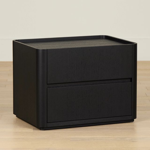 a black file cabinet sitting on top of a hard wood floor