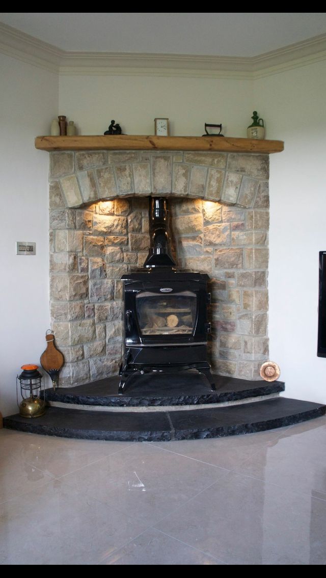 an old fashioned stove sitting in the corner of a room