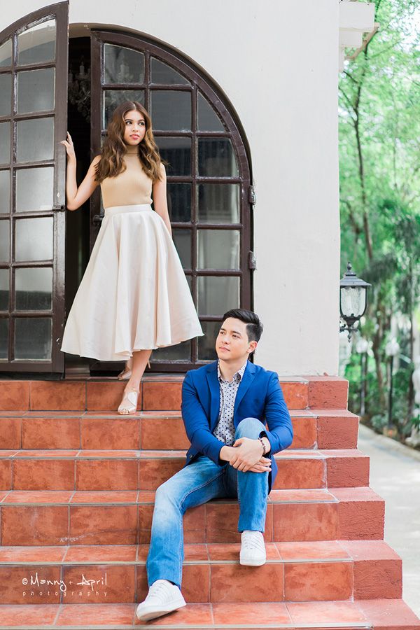 a man and woman are sitting on the steps