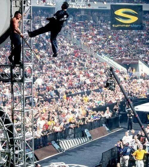 a man is performing tricks on a pole in front of an audience at a concert