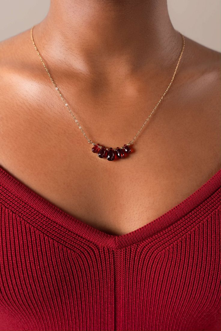 The Elodie necklace reflects your innate elegance, this delicate gold-filled necklace is handcrafted with 5 Mozambique garnet drops will make your outfit standout with their deep red hues. Packaged in an elegant plastic-free reusable jewelry box, they make the perfect gift or special treat for oneself.  14k gold-filled chain in 3 size options (40cm/45cm/50cm) Natural Mozambique garnet stones Hypoallergenic, suitable for even the most sensitive skin Delivered in a 100% silk jewelry pouchette insi Garnet Necklaces For Gifts, Burgundy Garnet Necklaces For Gifts, Elegant Amber Birthstone Necklace For Gift, Dainty Garnet Necklace For Gift, Elegant Red Garnet Necklaces, Elegant Red Garnet Necklace, Gold Garnet Necklace For Gift, Elegant Gold Garnet Necklace, Burgundy Ruby Necklace As Gift