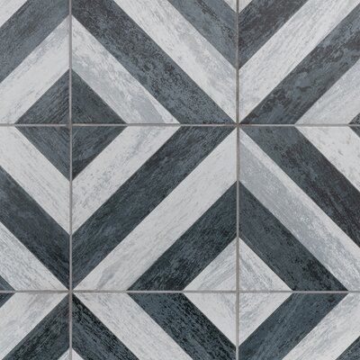 a black and white tile pattern with diagonal stripes