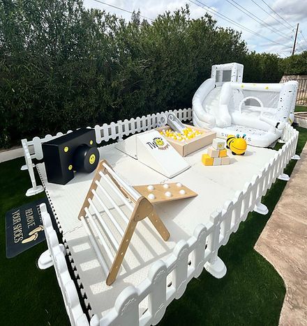 an inflatable water slide is set up on the lawn to be used as a picnic table