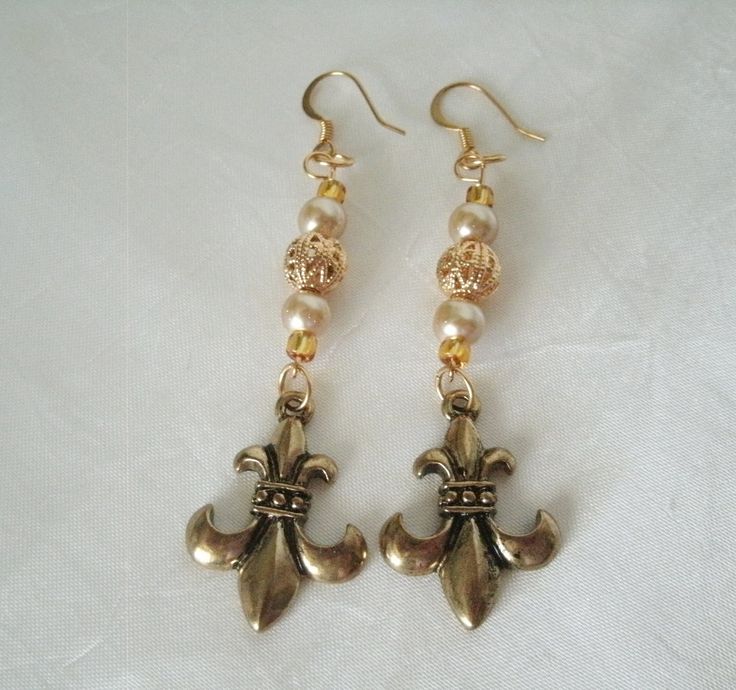 "These beautiful earrings have gold plated filigree beads, glass pearl beads, seed beads and brass fleur de lis charms. 2.5\" long from hook bottom." Victorian Gold Plug Earrings, Ornate Historical Design Earrings, Antique Gold Earrings With Historical Design, Ornate Gold Earrings With Historical Design, Gold Victorian Baroque Earrings, Gold Baroque Victorian Earrings, Antique Gold Chandelier Earrings, Gold Earrings With Historical Design For Wedding, Victorian Gold Dangle Earrings