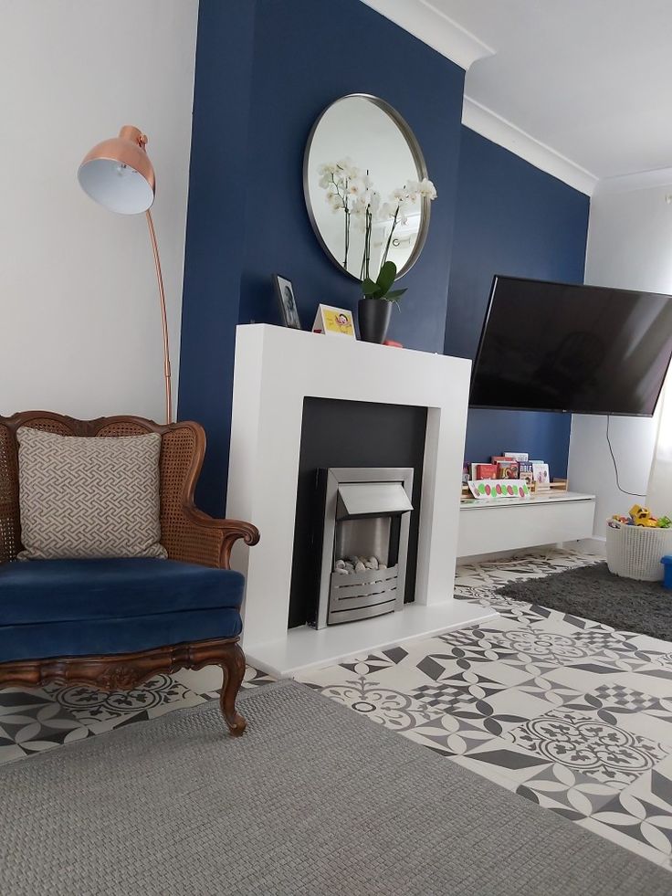 a living room with blue walls and a fireplace