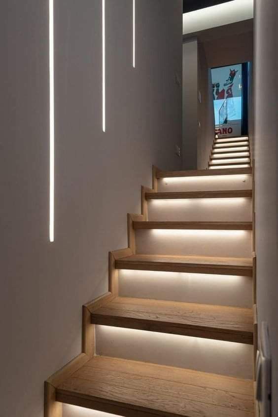 the stairs are illuminated with leds to give them more light than they appear in this hallway