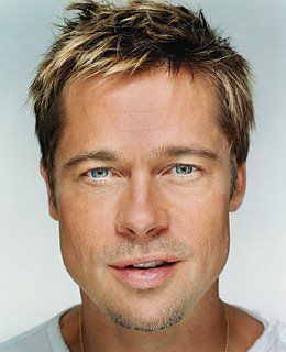 a man with blonde hair and blue eyes looks at the camera while wearing a white t - shirt