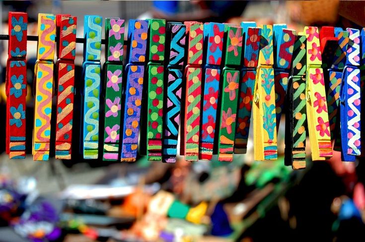 colorful ribbons are hanging from a line outside