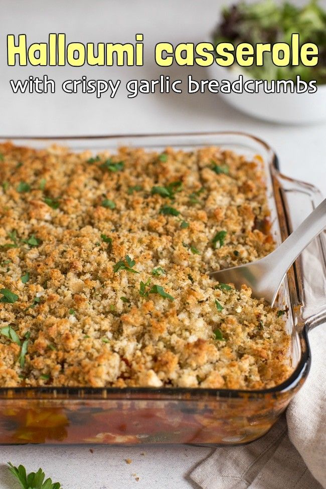 a casserole dish filled with crispy garlic breadcrumbs and topped with parsley