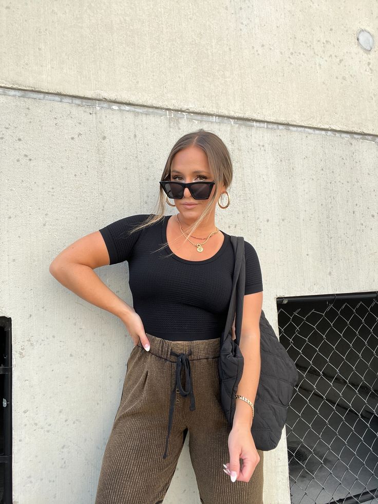 SEAMLESS WAFFLE SCOOP NECK MIDI CROPPED TEE COLOR: BLACK MODEL IS WEARING ML 92% NYLON/8% SPAN RUNS TRUE TO SIZE MODEL MEASUREMENTS: WEIGHT 150 LBS, 5’2”, SIZE 6, BUST 35”, WAIST 28”, HIPS 37”, BRA SIZE 34D Black Scoop Neck T-shirt For Fall, Black Ribbed Tops For Athleisure, Black Ribbed Athleisure Top, Sporty Black T-shirt For Fall, Black Scoop Neck T-shirt For Everyday, Black Scoop Neck Top For Work, Black Scoop Neck T-shirt, Black Ribbed Relaxed Fit T-shirt, Black Relaxed Fit Ribbed T-shirt