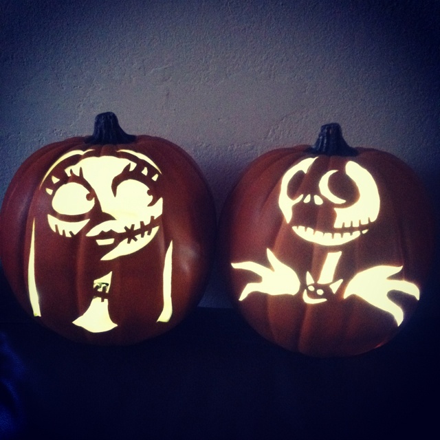 two carved pumpkins with faces on them