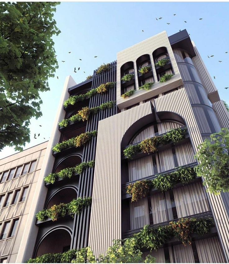 an apartment building with plants growing on the balconies