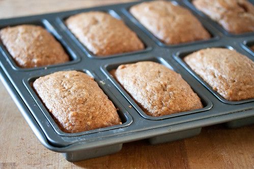 freshly baked muffins in a baking pan on a wooden table, ready to go into the oven