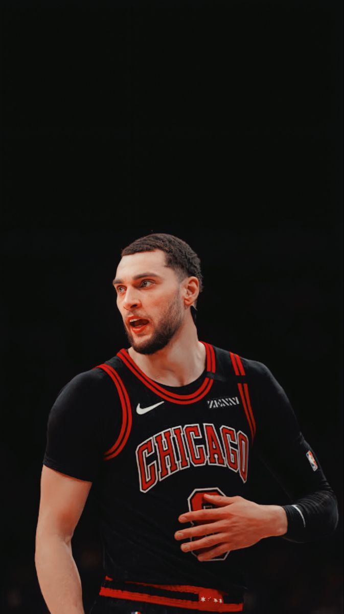 the chicago bulls basketball player is standing in front of his team's black jersey