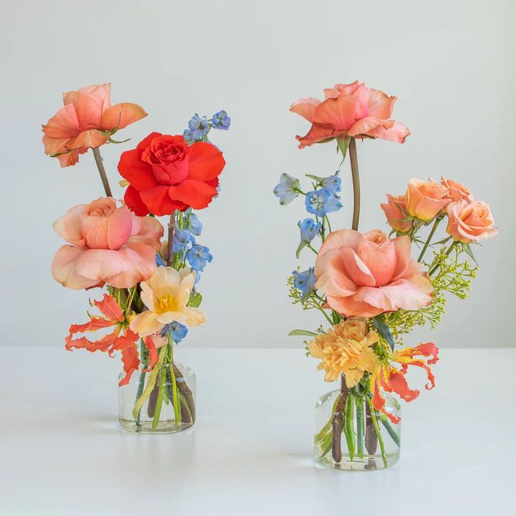 two vases filled with different types of flowers